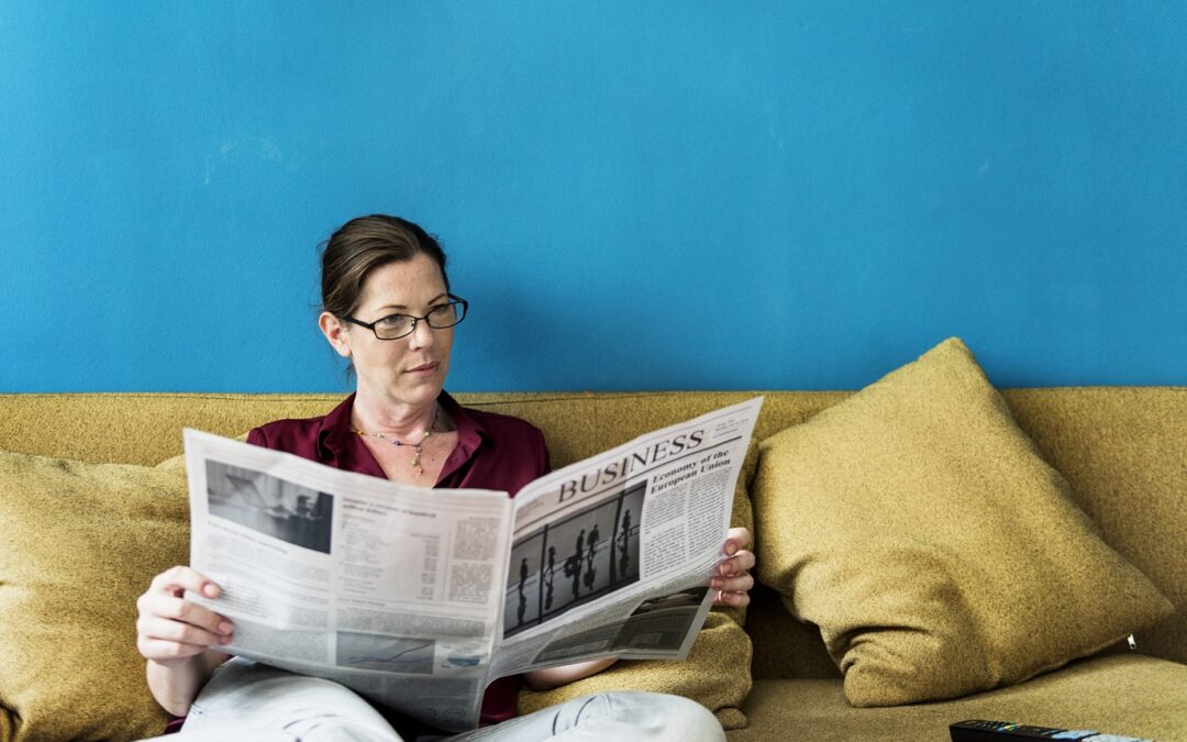 Caucasian woman reading the newspaper